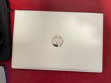 hp laptop with hard drive and accessories sitting on a red table