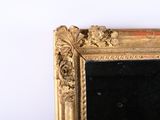 a picture of a gold framed mirror on a white wall