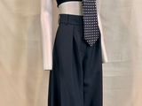 a mannequin wearing a black dress and a tie