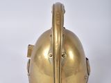 brass helmet on a white surface with a white background