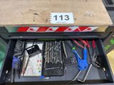 a drawer full of assorted tools on a table