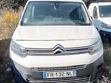 two white vans parked next to each other in a field