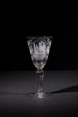 a wine glass that is sitting on a table