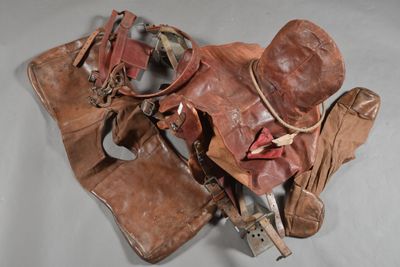 a brown leather bag and a pair of shoes on a table