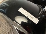a close up of a black motorcycle with a sticker on it