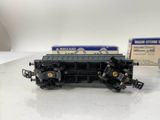 a black train car sitting on a table next to a box