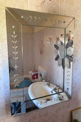 a bathroom with a sink and a mirror on the wall
