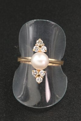 a ring with a pearl and a diamond on it