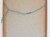 an empty wooden box with a string wrapped around it