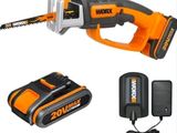 a corded saw with a battery and charger on a white background