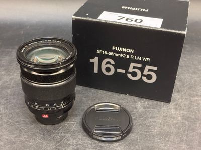 the lens is sitting next to the box of the camera