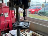 une perceuse posée sur une table devant une fenêtre