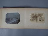 an old photo of a book opened to show a picture of a beach