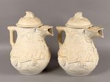 pair of antique creamwares with floral designs on them