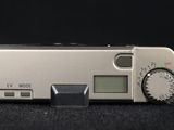 an image of a silver digital camera on a black background