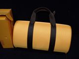 a yellow suitcase and a yellow box on a black background