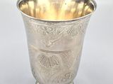 a silver cup that is sitting on a table