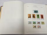 an open book with stamps on it on a table