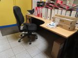 a desk with a chair and a computer on it