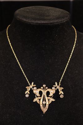 Collier en or jaune 9 K (375) à décor de volutes serties de …