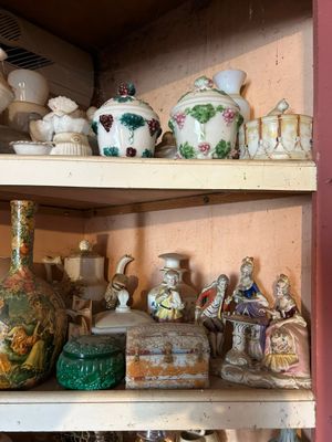 a shelf with many different types of vases on it