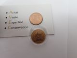 two coins on the table next to each other