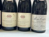four bottles of wine are lined up on a table