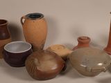 many different types of vases sitting on a table