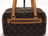 a brown and tan louis vuitton handbag on a white background