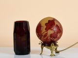 a red vase and a brown vase sitting on a table