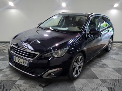 la voiture noire est garée sur un sol en damier dans le garage