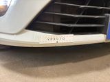 a close up of a car ' s grille with a sticker on it