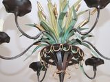 a chandelier with a potted plant on top of it