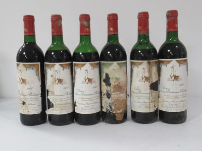 six bottles of wine are lined up on a table