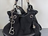 the black purse is sitting on top of a black table