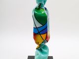 a sculpture of a colorful vase on a black stand