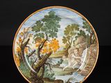 an image of a plate with a painting on it on a black surface