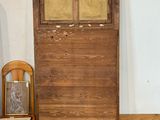 an old wooden door and a chair in a room
