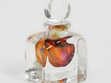 une petite bouteille en verre contenant une fleur