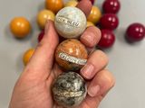 a person holding a bunch of rocks in their hand