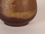 a brown vase sitting on a table with a white background