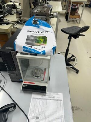 une boîte posée sur un micro-ondes, lui-même posé sur une table