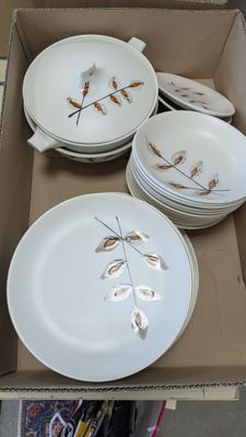 a cardboard box with a bunch of plates and bowls in it