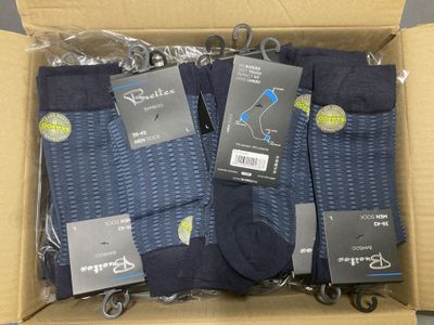 four pairs of men ' s socks in a box
