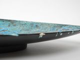 a black bowl with a blue patt on it