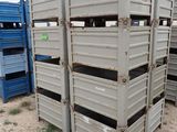 many crates that are stacked up in the dirt