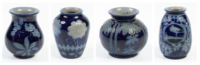 four different views of a blue vase with a flower design on it
