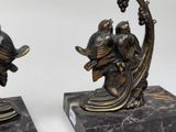 pair of antique bronze figurines of birds on a crescent
