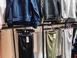a lot of clothes hanging on a rack in a store