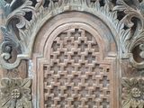 an old wooden door with a decorative design on the outside